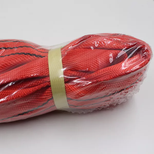 Red 5T Round Sling material packaged in a plastic wrap and a mesh cover.