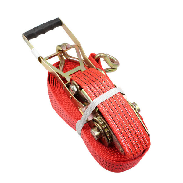 The 2" LC 2500kg Ergo Ratchet Strap with a black handle and gold parts is neatly coiled and secured with a white band.