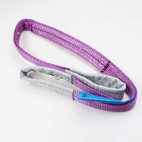 The purple 1T Synthetic Webbing Sling with reinforced loops lies coiled on a white surface, marked by its blue label.