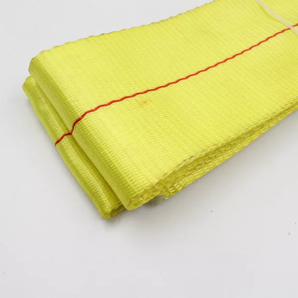 A folded yellow 1T Polyester Endless Webbing Sling cloth with a red stitched edge.