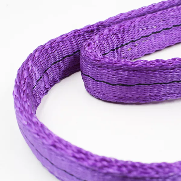 A coiled purple 1T synthetic webbing sling on a white background.