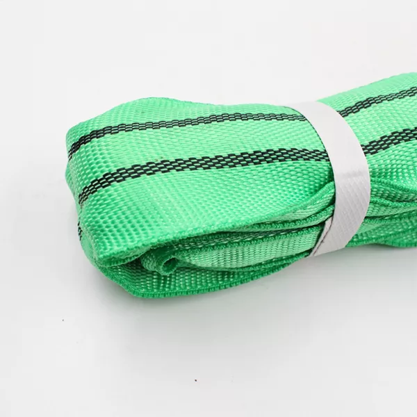 A rolled-up green 2T EN 1492 2 Round Sling secured with a white band against a white background, meeting EN 1492-2 round sling standards.