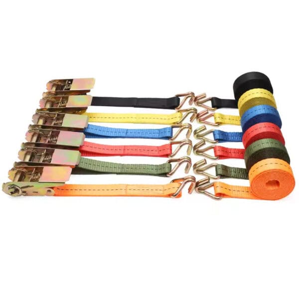 Assorted colorful and black 1" LC 100% Polyester Flatbed Winch Straps with flat hooks and a rolled-up strap set on a white background.