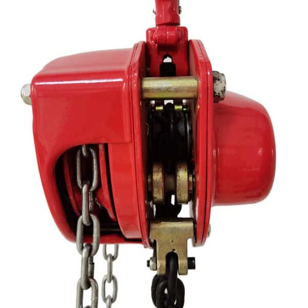 Close-up of a red manual chain hoist, showcasing its visible gears, chain, and robust design from the side.