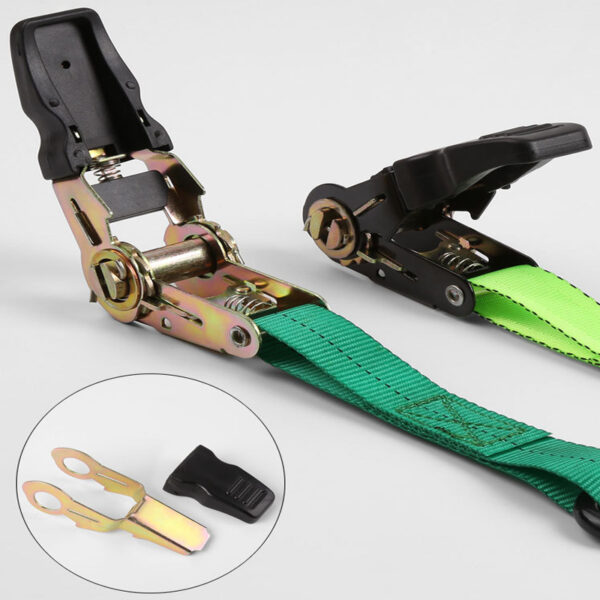 The Tie Down Buckle Set has 2 metal ratchet buckles with black handles, green straps, a yellow hook, and a black cap.