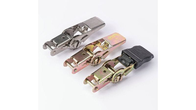 Three toggle latches on white: one silver, two gold, and one includes a black plastic part.