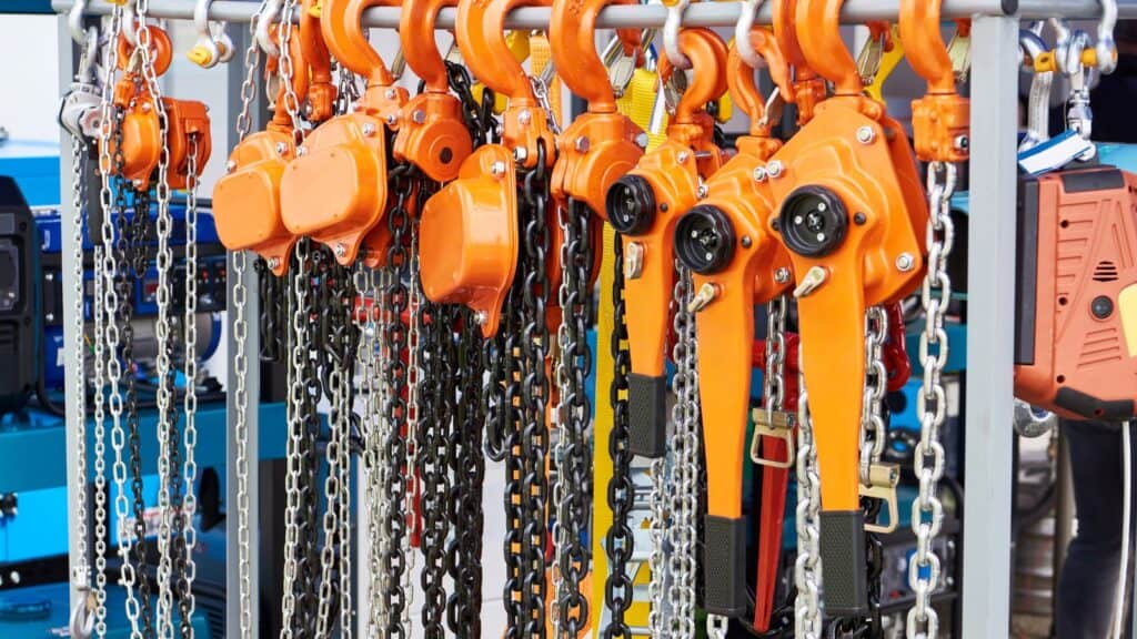 manual chain hoists stacked on a rack
