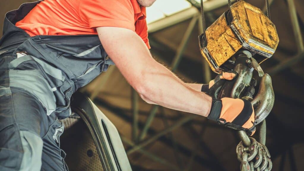 a worker attaching loads to a hoist